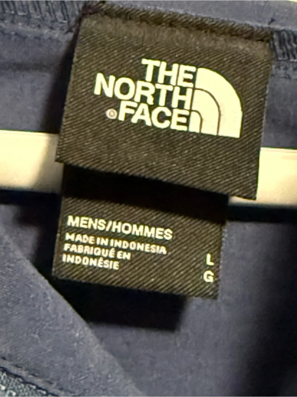 The North Face Navy Blue Men’s Jacket with Black Logo Tag